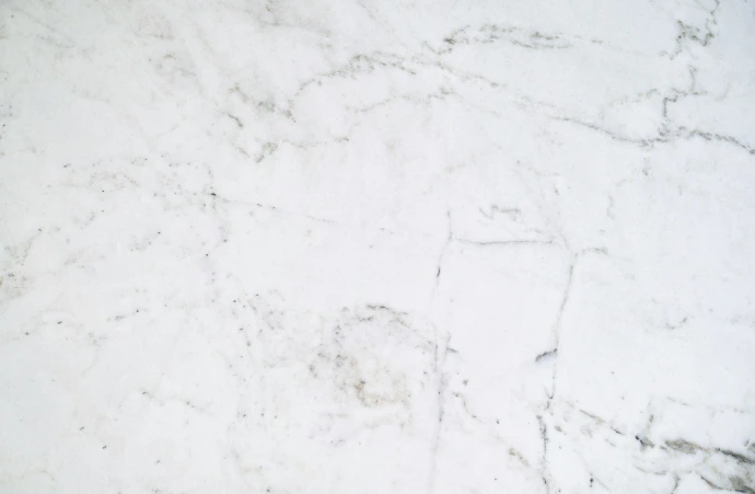 a close up of a white marble counter top